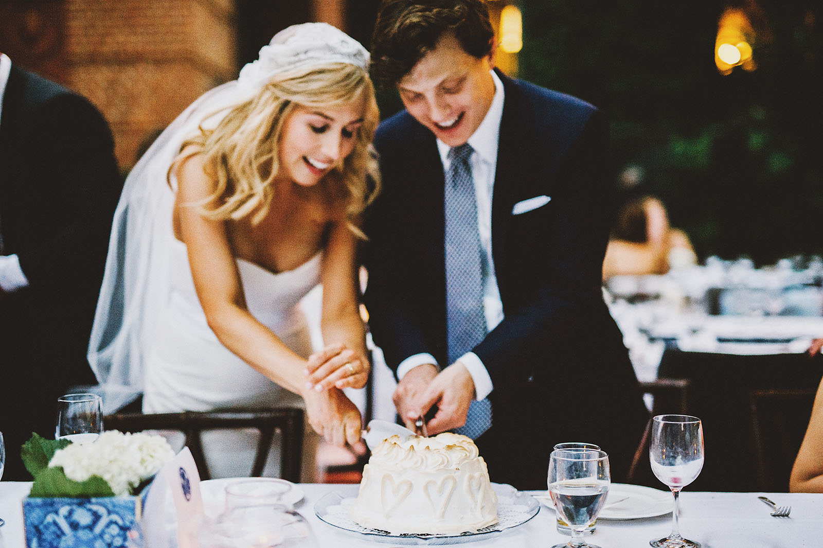 Bride and Groom cutting into their Baked Alaska cake | Portland Town Club Wedding