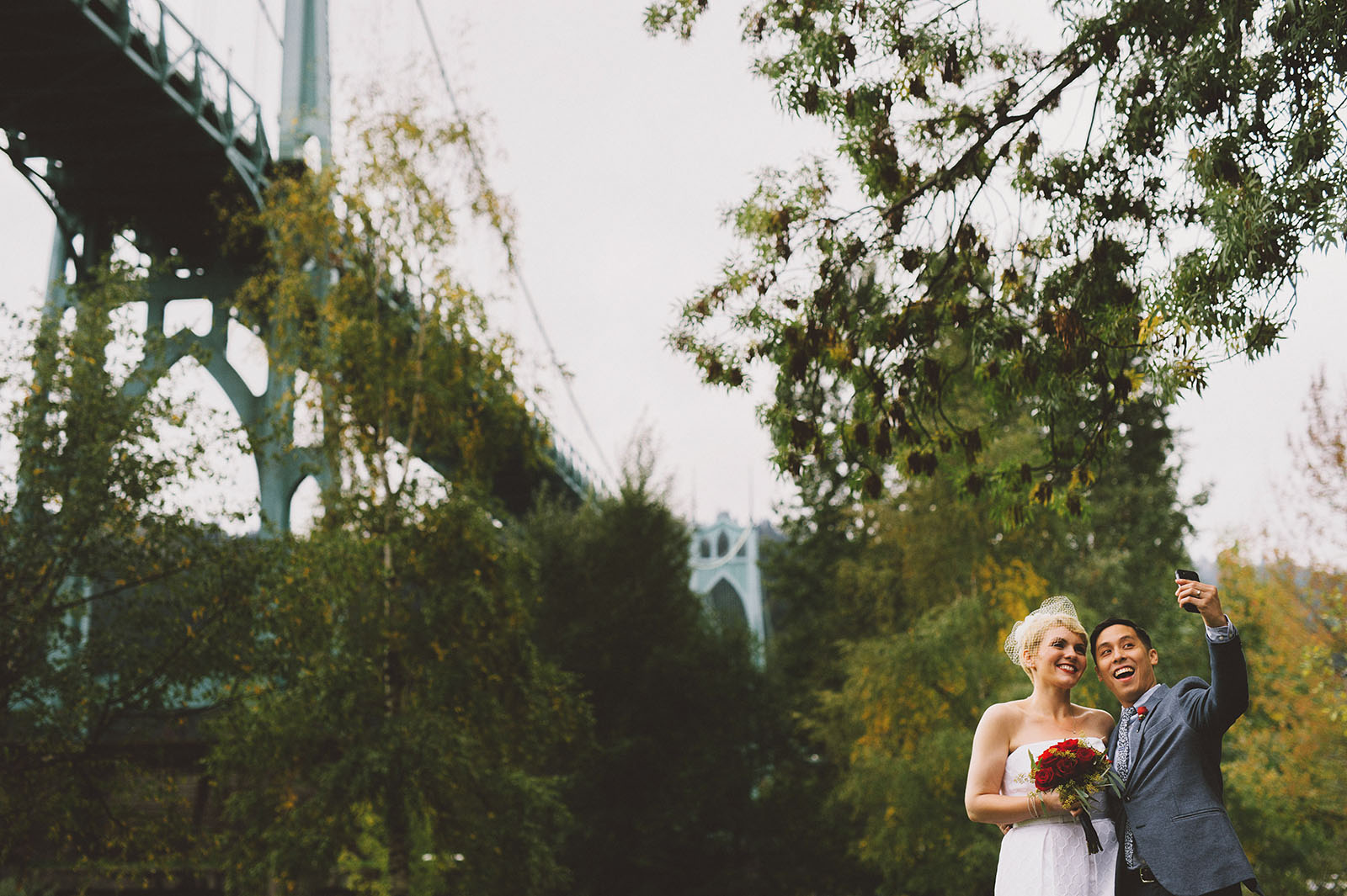Newlyweds taking a selfie under the St. John's Bridge | Portland Oregon Elopement