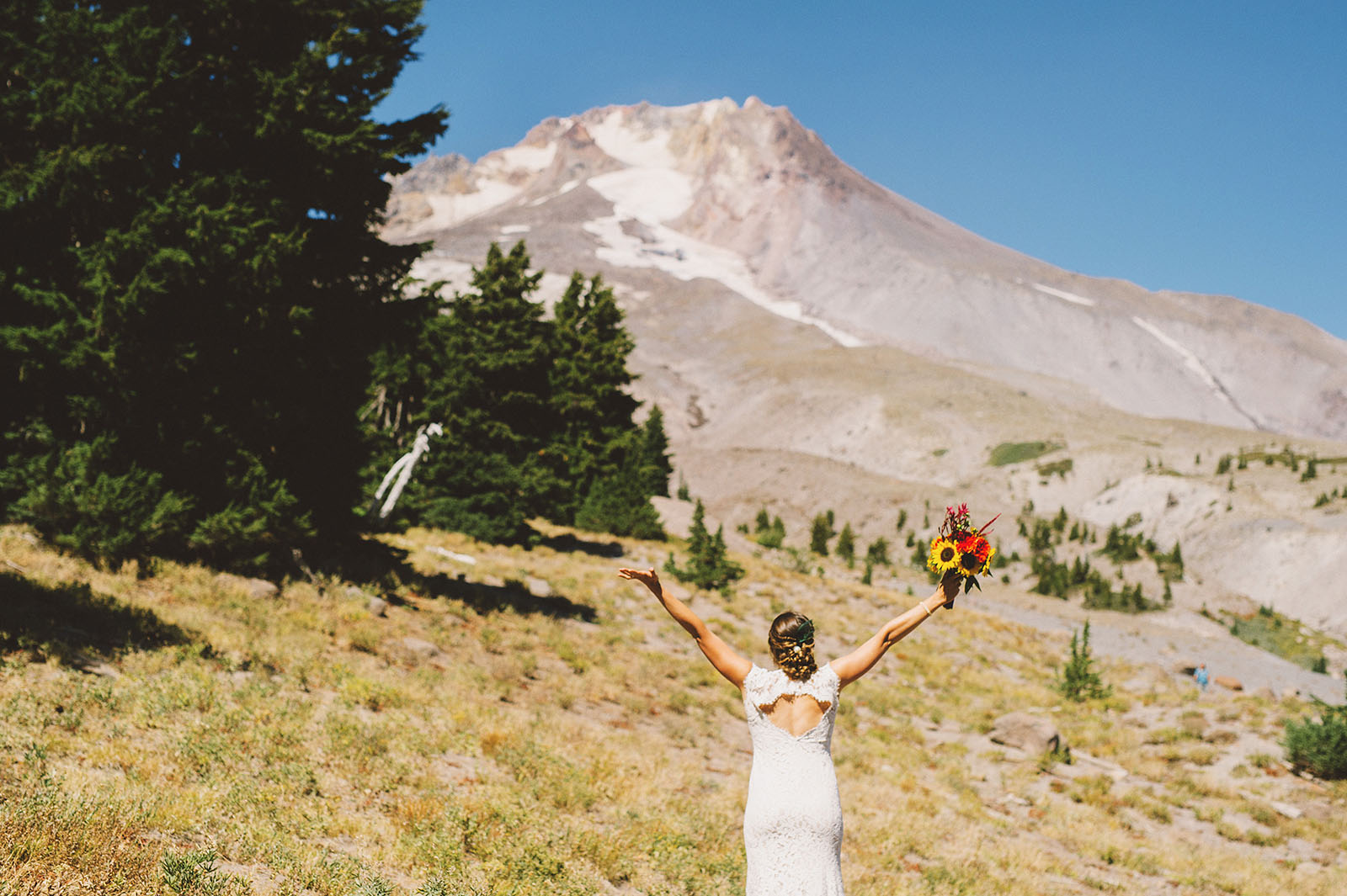 Bride waving hello to Mt Hood | Mazama Lodge Wedding