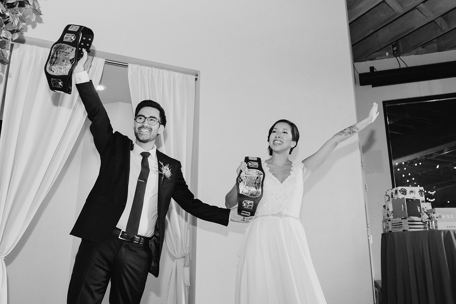 Bride and Groom's grand entrance with wrestling belts | Portland Castaway Wedding