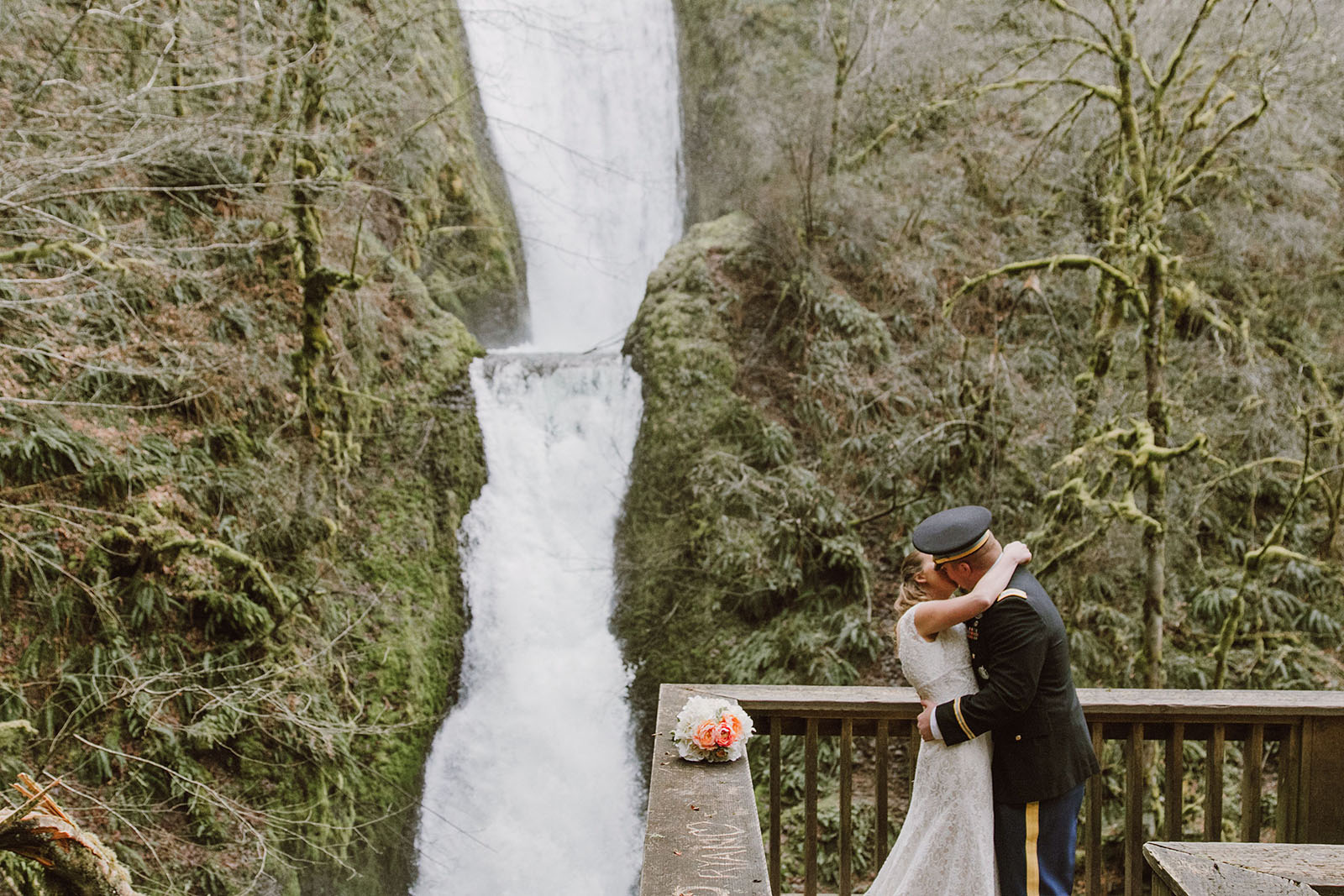 Bride and Groom hugging in front of a waterfall | Bridal Veil Elopement Photographer