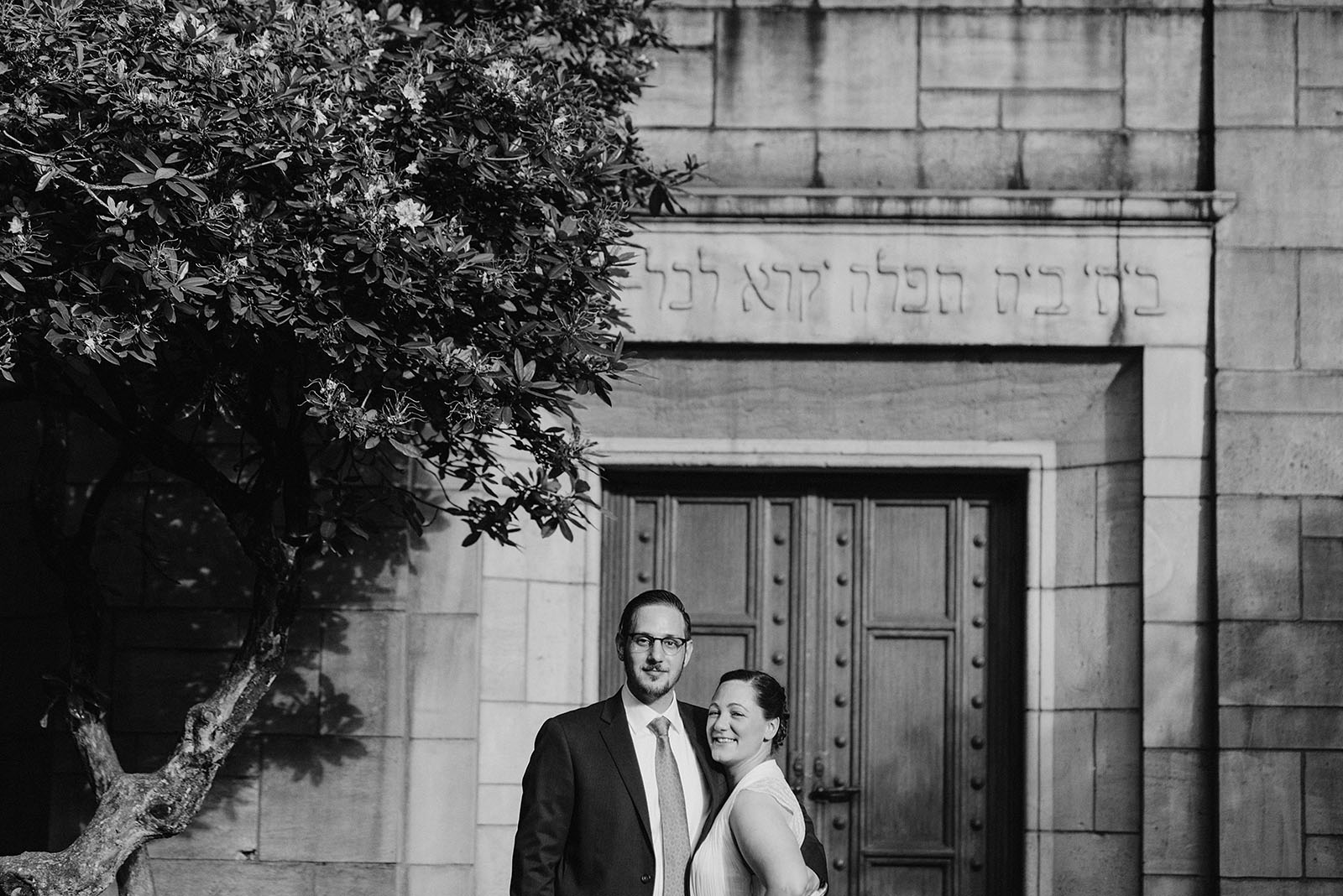 Bride and Groom posing outside of their Congregation Beth Israel wedding