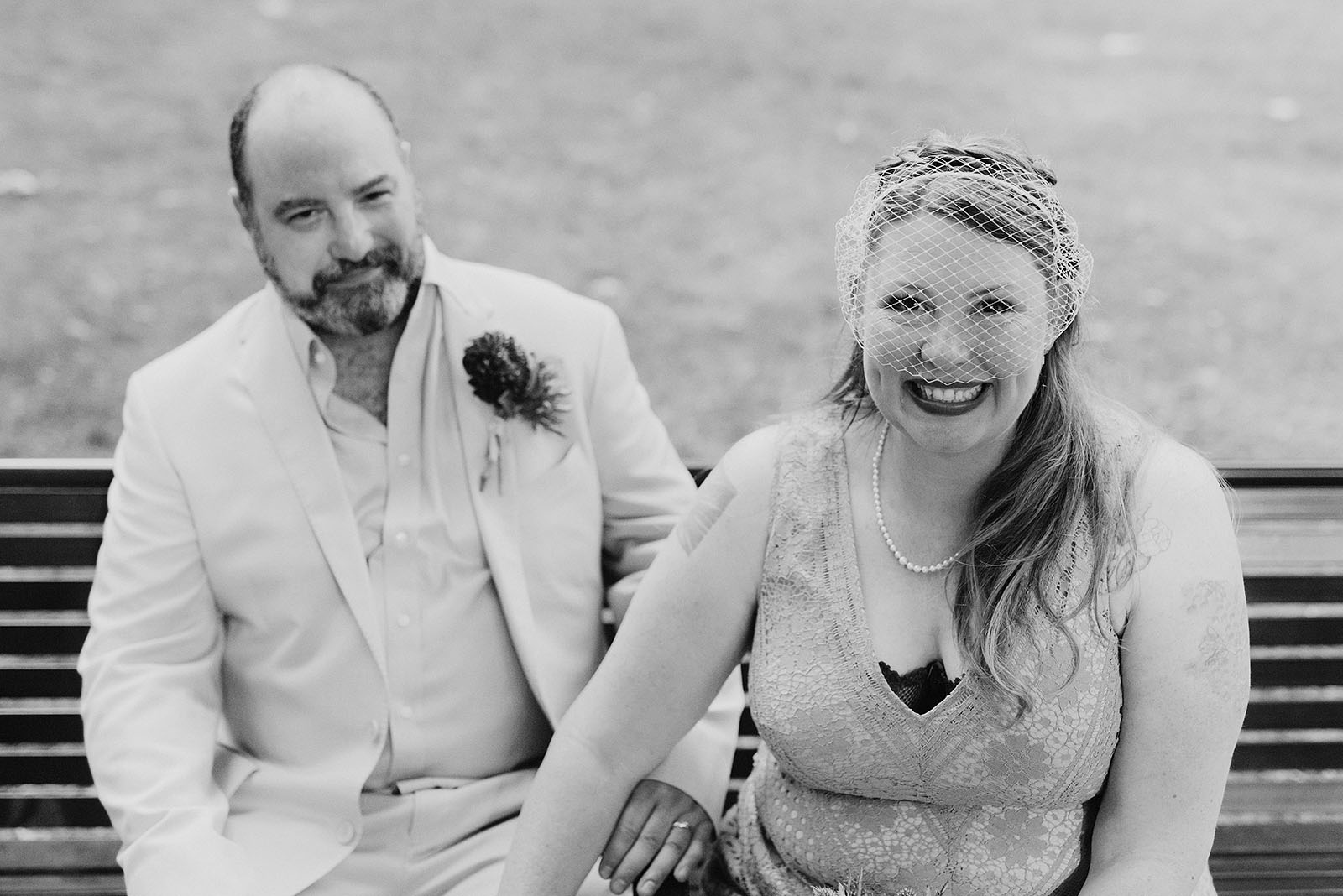 Bride and Groom posing on a park bench at an intimate Ned Ludd wedding