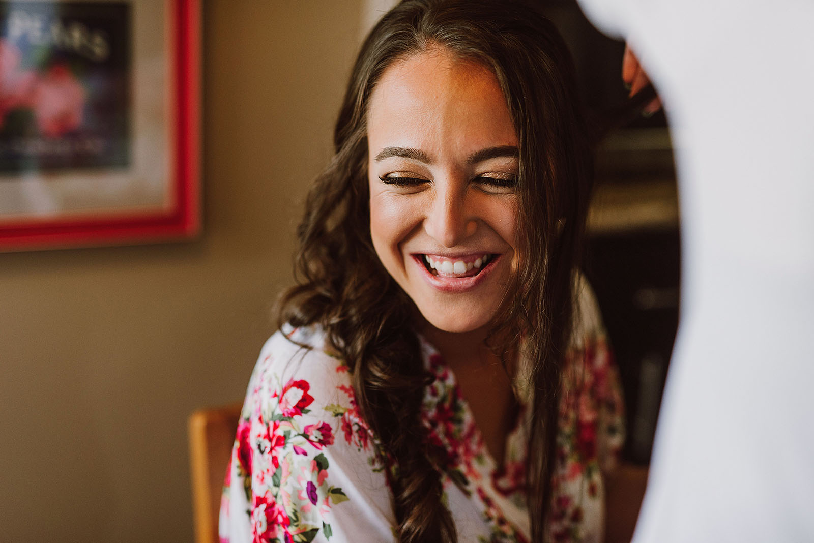 Bride smiling while getting her make-up done - Cedarville Lodge Wedding