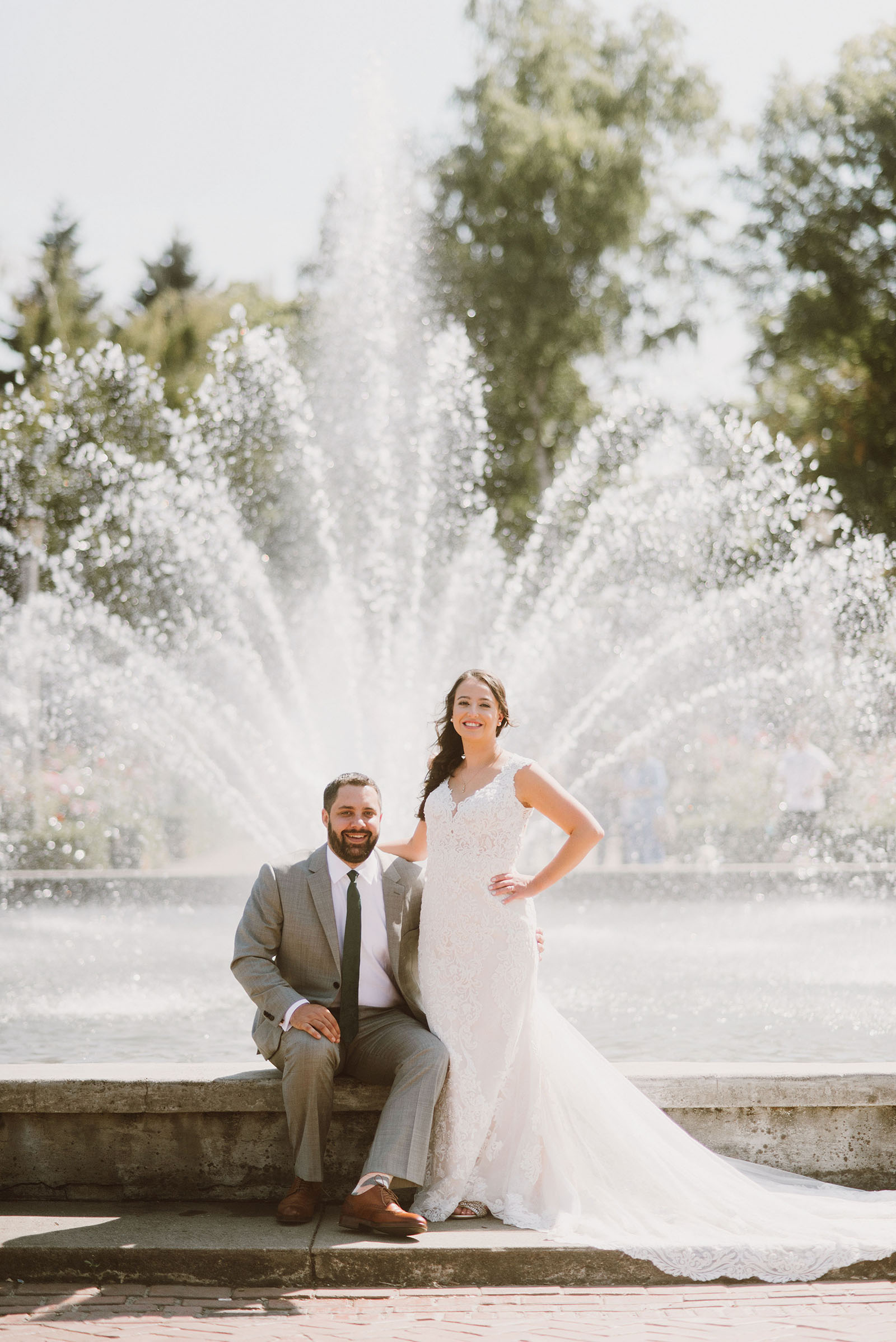 Bride and Groom posing in front of the water fountain in Peninsula Park