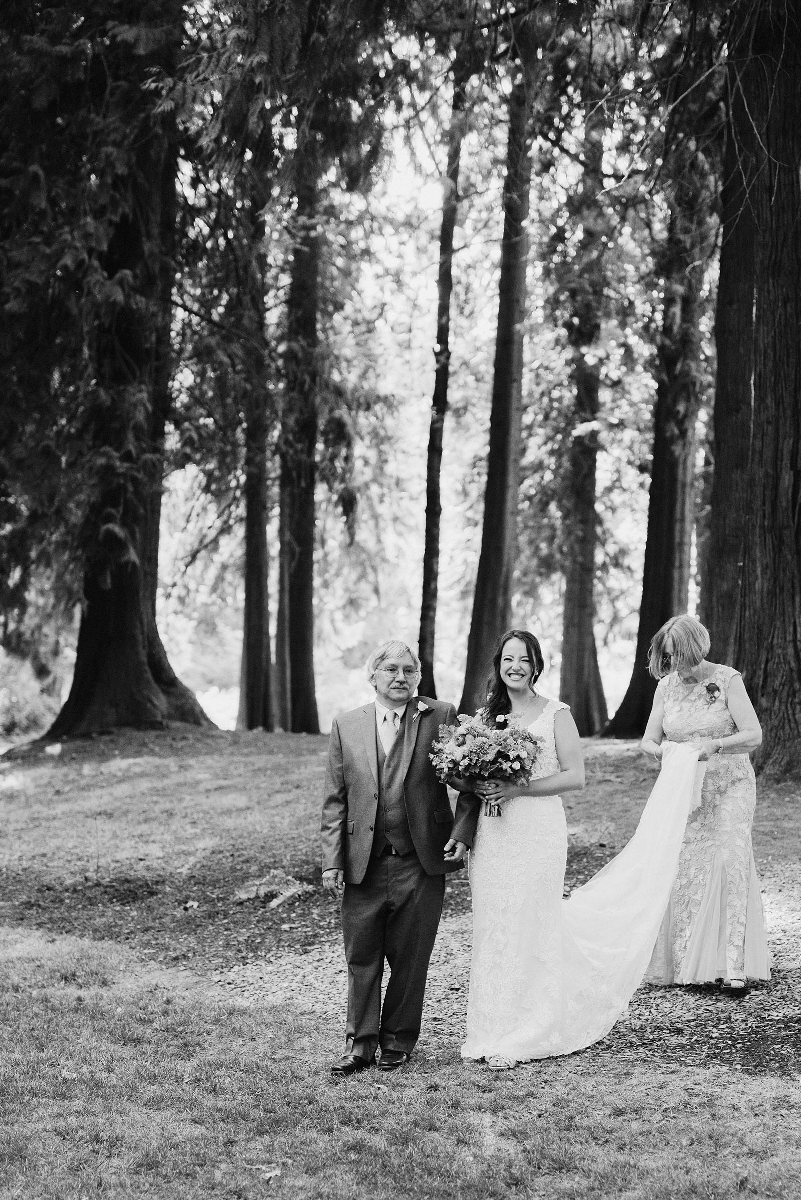 Bride walking down the aisle with her father and mother at a Cedarville Lodge Wedding
