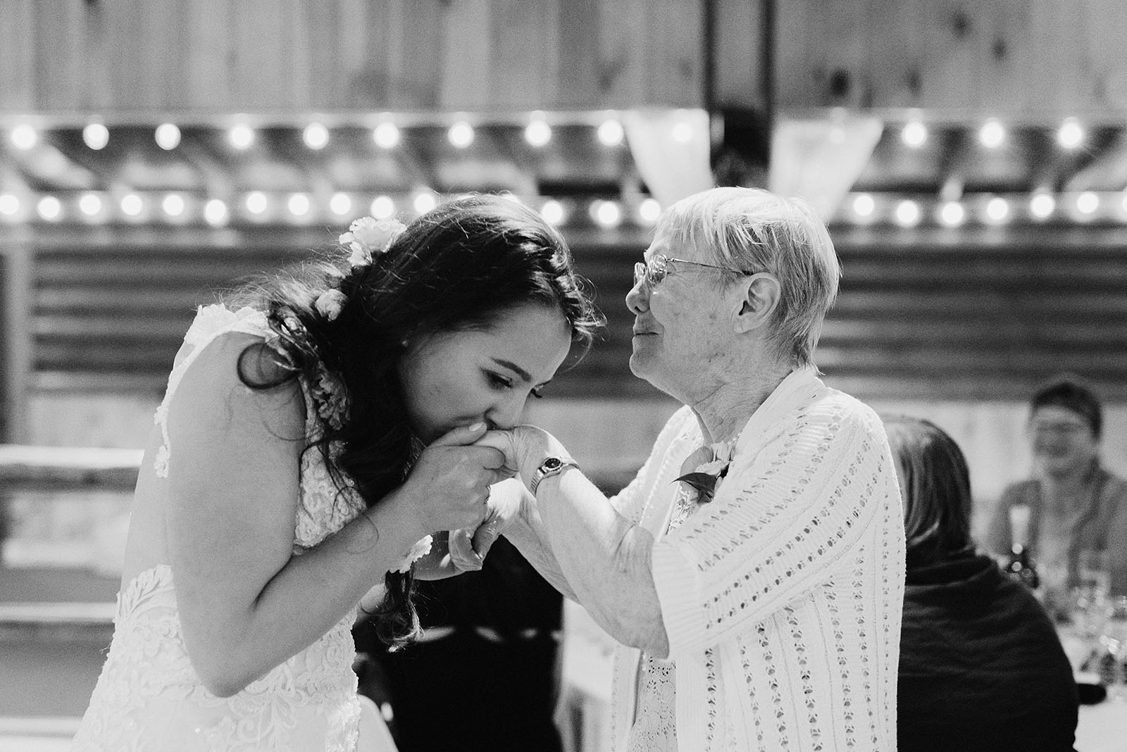 Bride kissing her grandmother during the toasts at a Cedarville Lodge Wedding