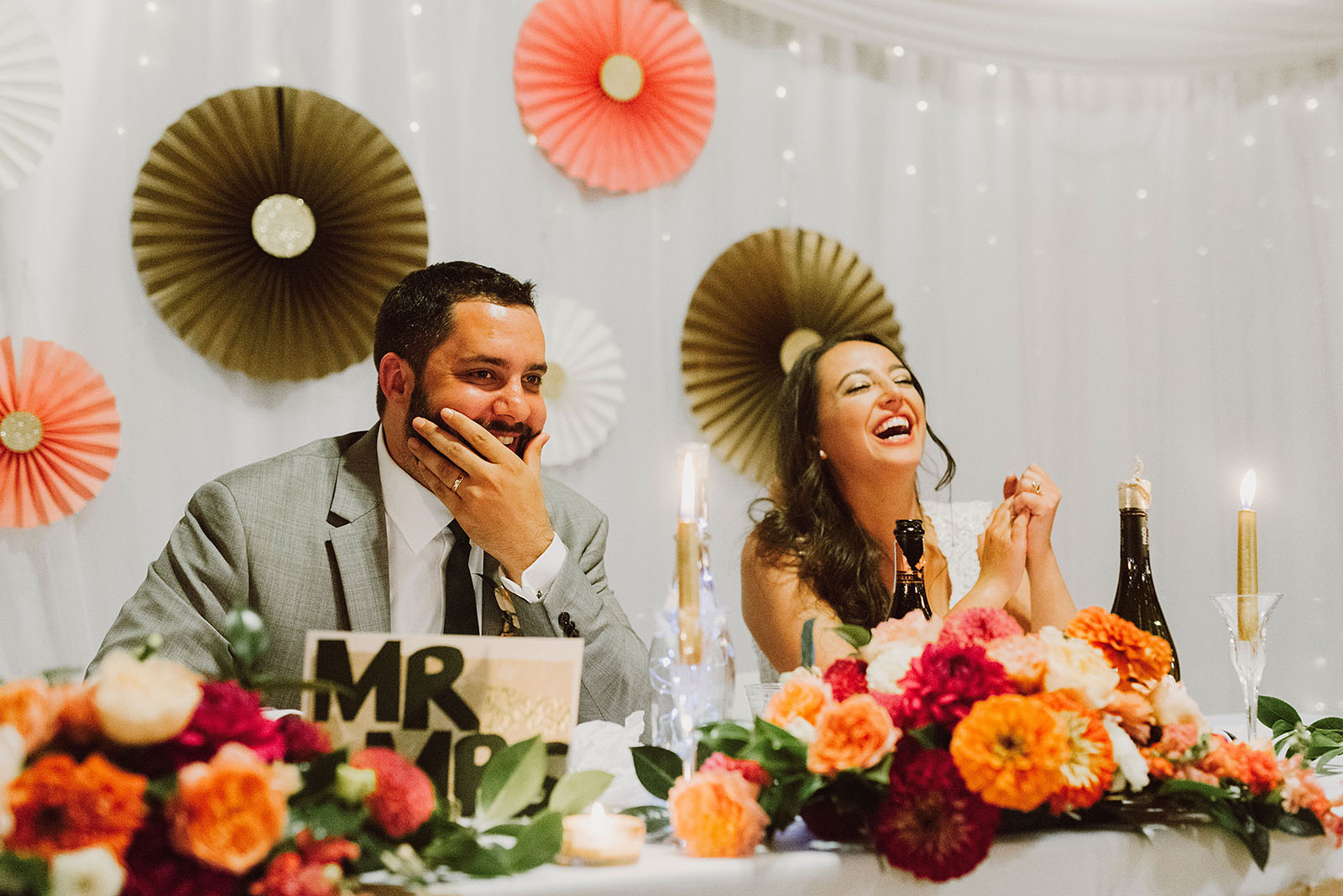 Bride and Groom laughing during the toasts at their Cedarville Lodge Wedding