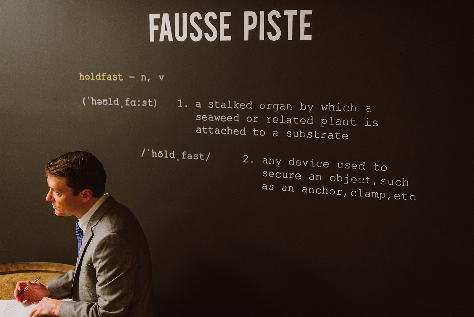 Groom writing vows in front of Fausse Piste - Intimate Restaurant Wedding in Portland, OR