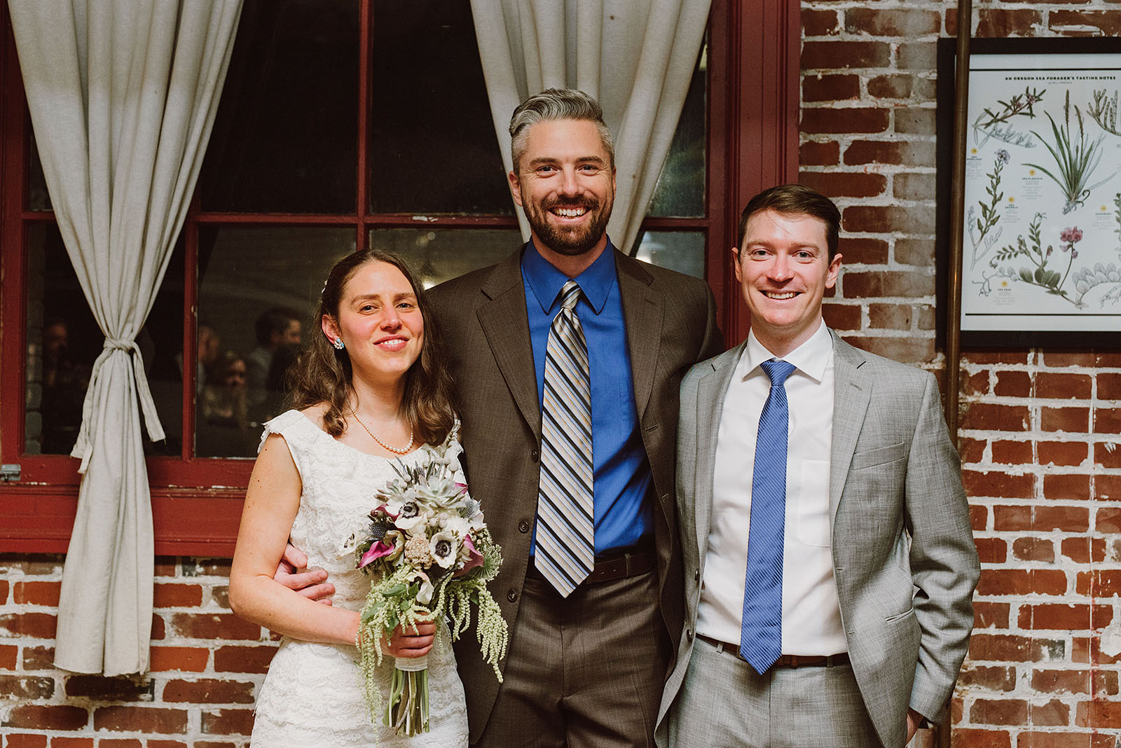 Portrait of bride and groom with their officiant at an Intimate Restaurant Wedding in Portland, OR