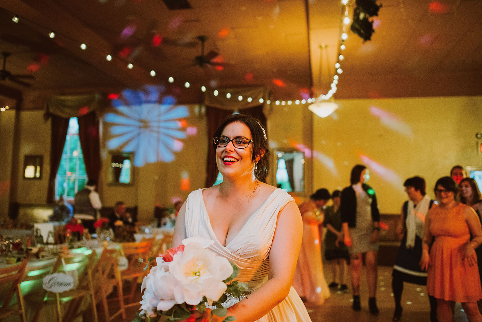 Bride tossing bouquet on the dance floor - Polaris Hall Wedding