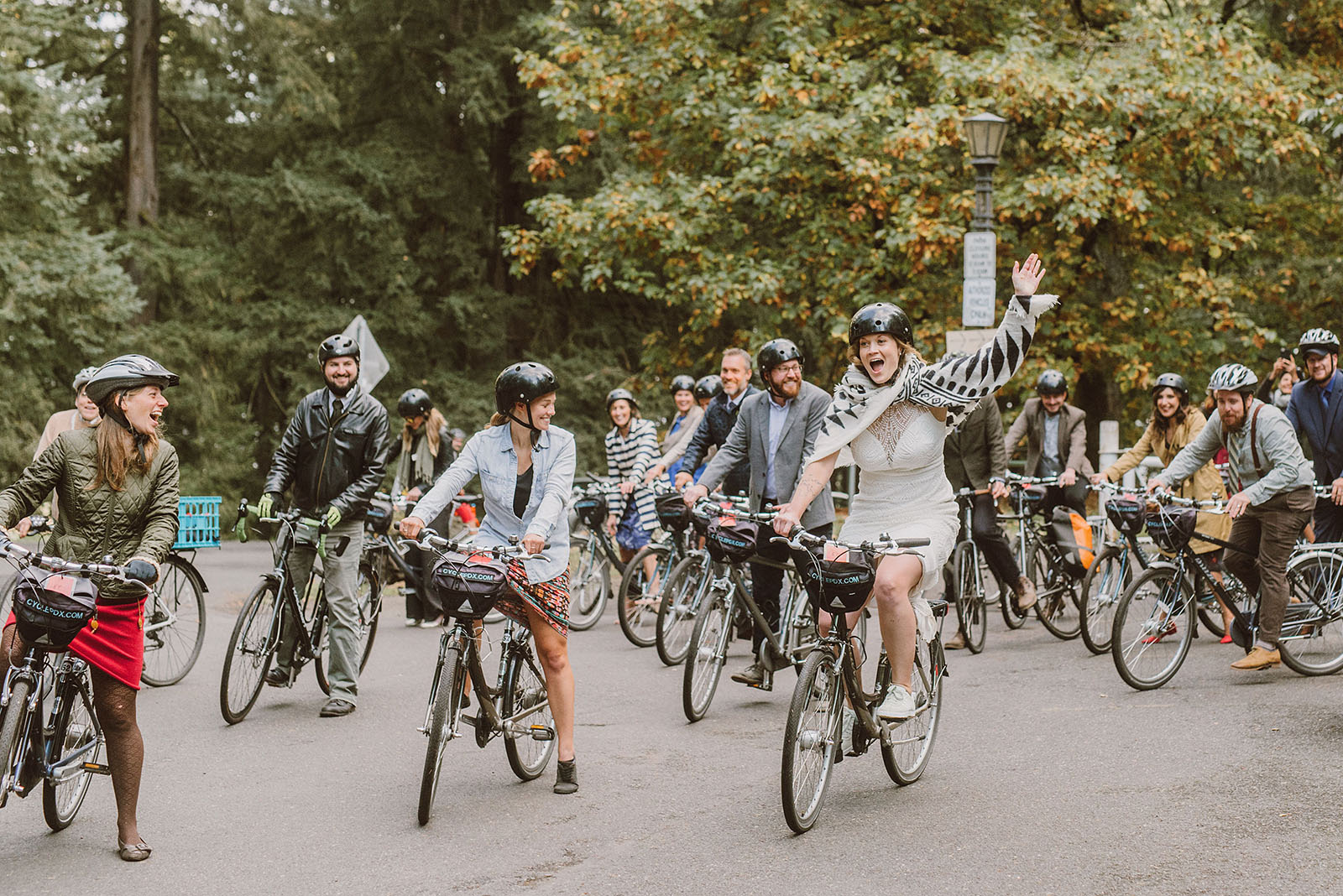 bride leading a bike parade from Mt Tabor - portland wedding photography