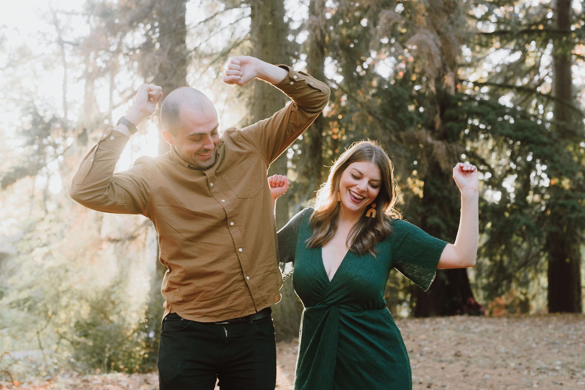 Newly engaged couple bumping butts in Laurelhurst Park | Portland Wedding Photographer